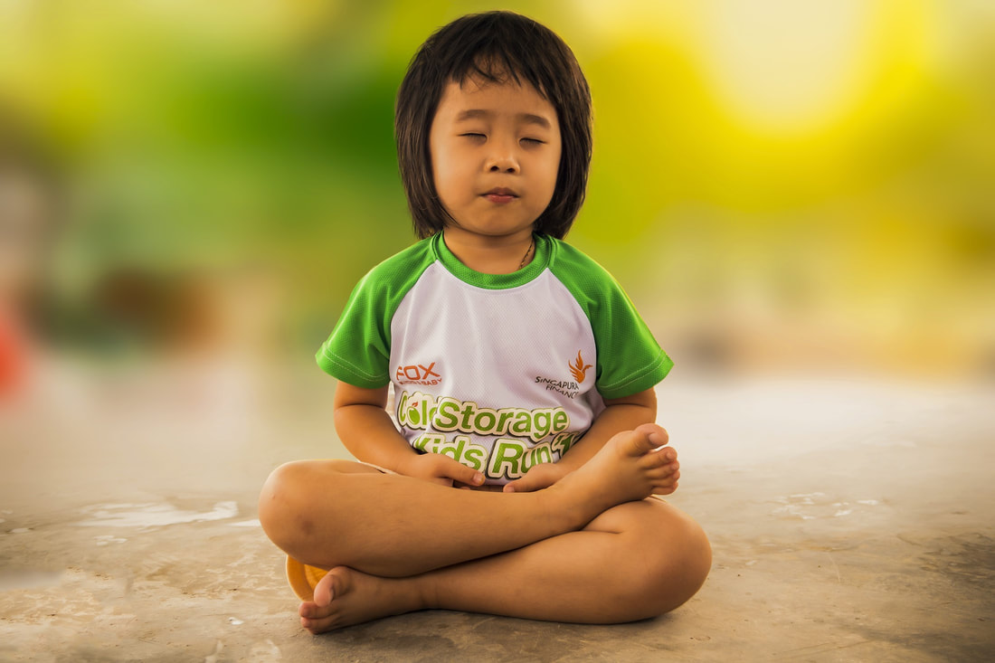 Picture of a child siting with eyes closed